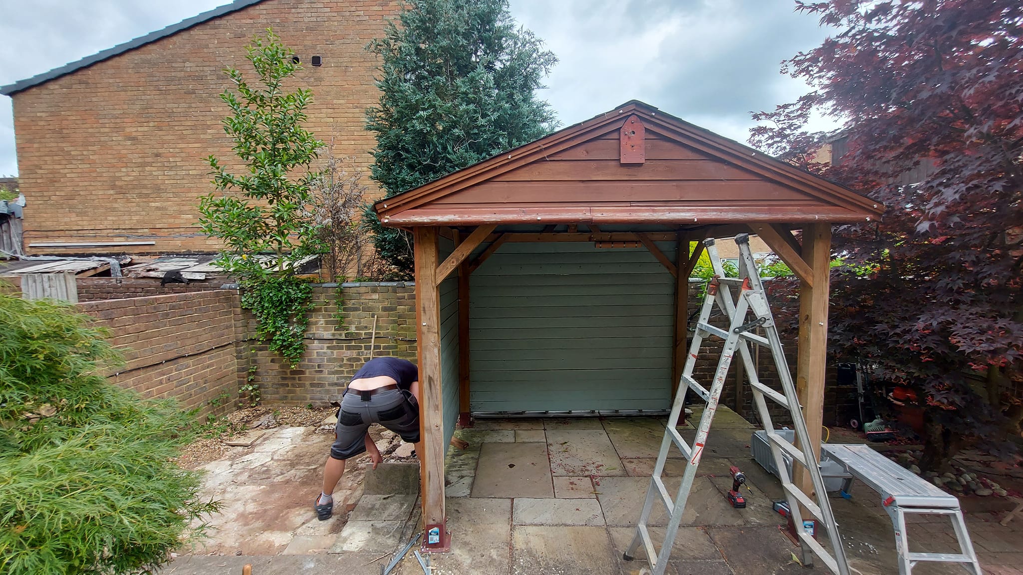 Worker removing slabs from patio